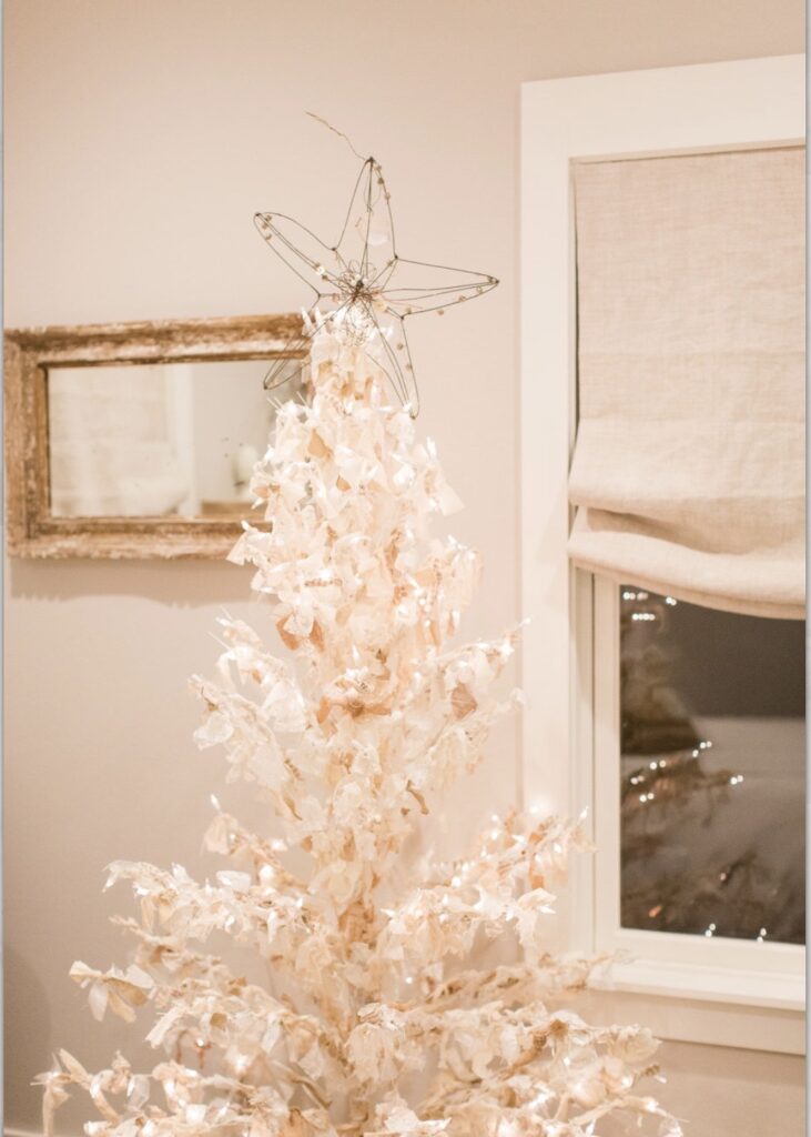 white wire Christmas tree with lights and tied with fabric strips to create a "rag tree".  A wire star is the tree topper