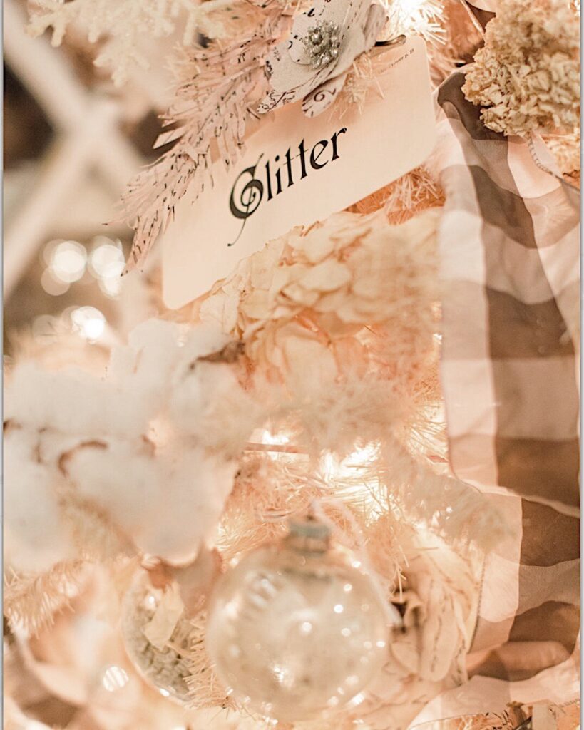 flash cards with Christmas words are used for christmas ornament on the white vintage Christmas tree.  