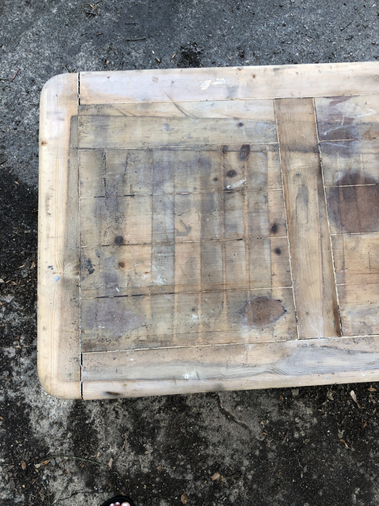 top view of light wood coffee table with a stained top