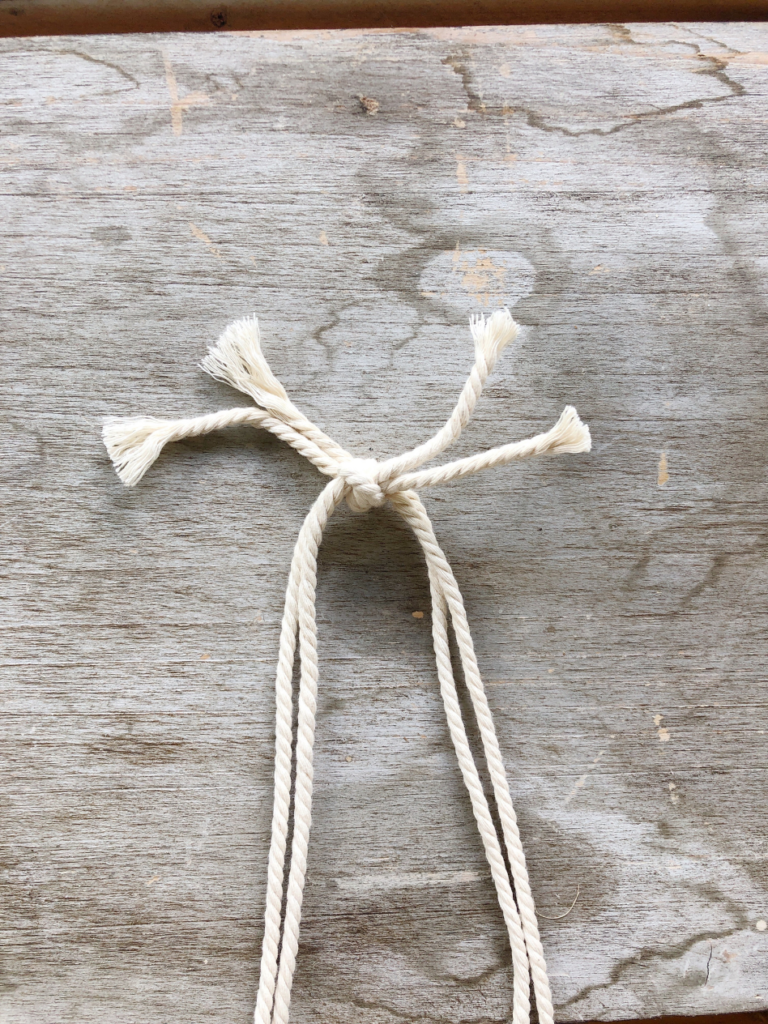 4 strands of macrame cording tied in a knot at the end
