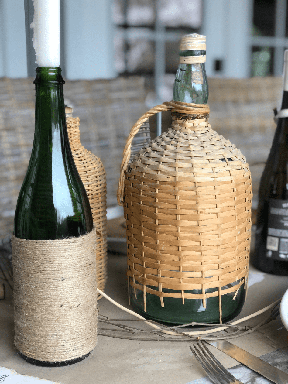 close up of 3 demi john vases on rustic italian theme centerpiece tablescape