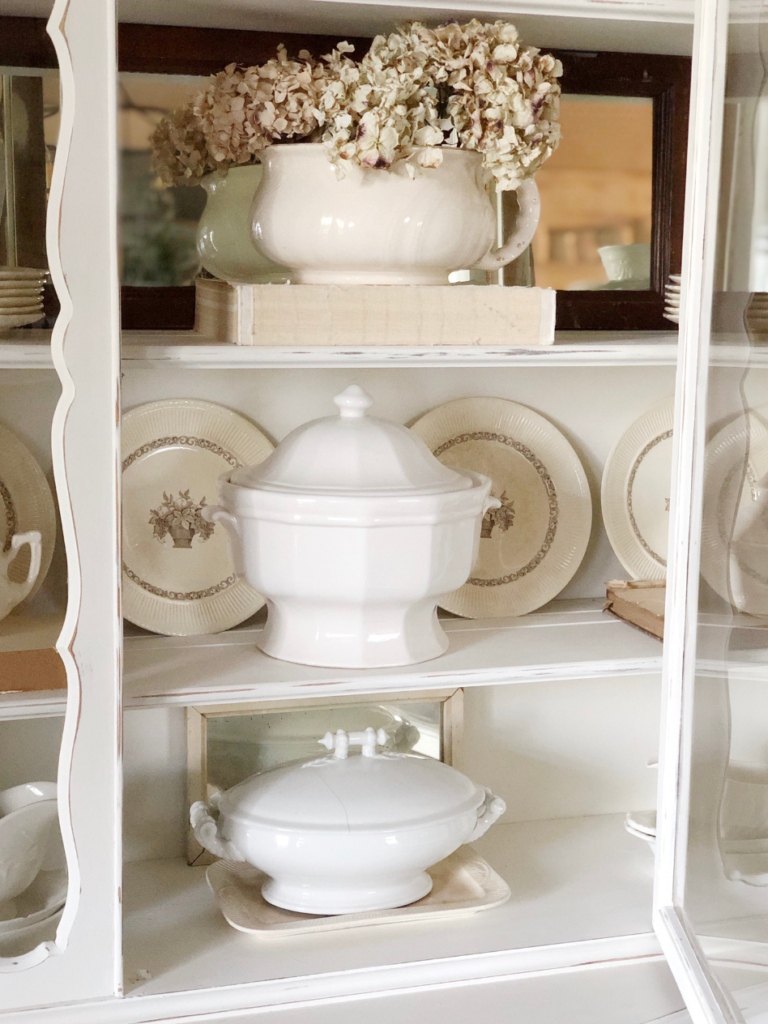 3 white soup tureen and white ironstone plates in white china hutch